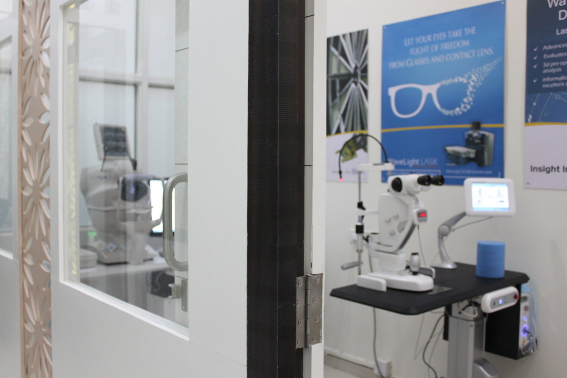 Doorway between the consultation room and LASIK diagnostic suite at Insight Institute, with the Oculyser II visible through the open glass door